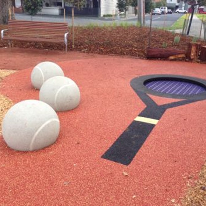 Trampoline in the style of a tennis racquet with giant tennis balls provided a place to sit