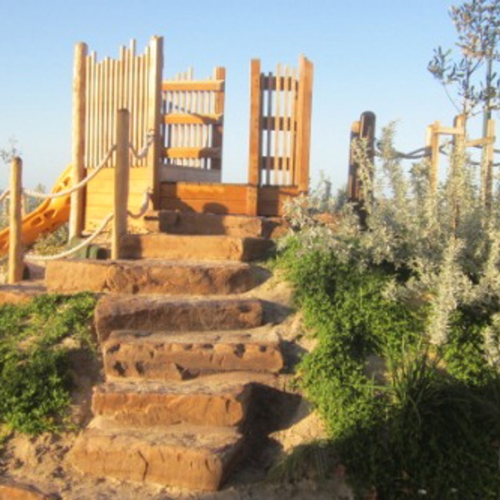 Stone steps lead up to the top of a slide
