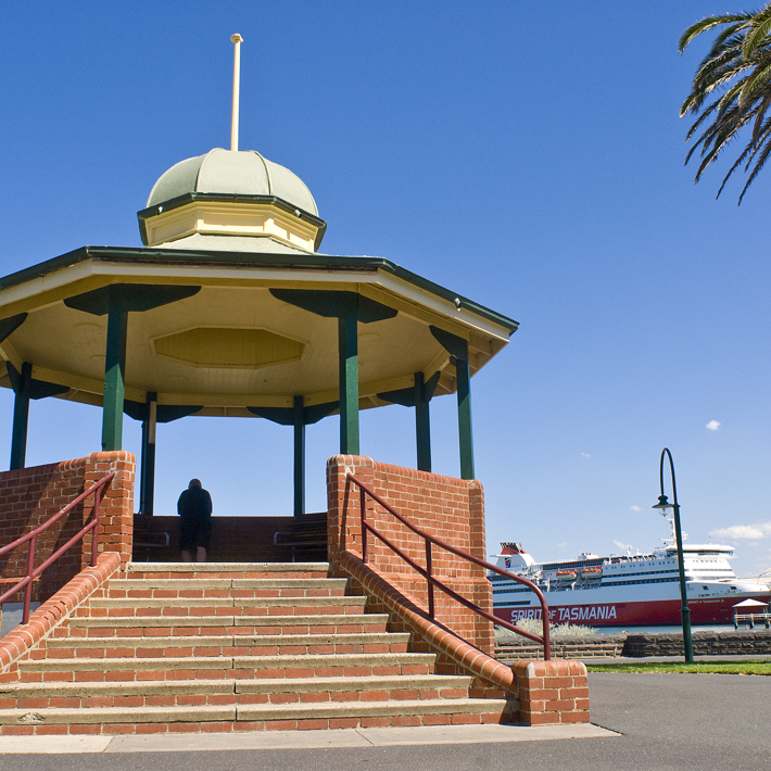 Port Melbourne bandstand rotunda provides a viewing platform over the Bay towards the Pier with the Spirit of Tasmania docked