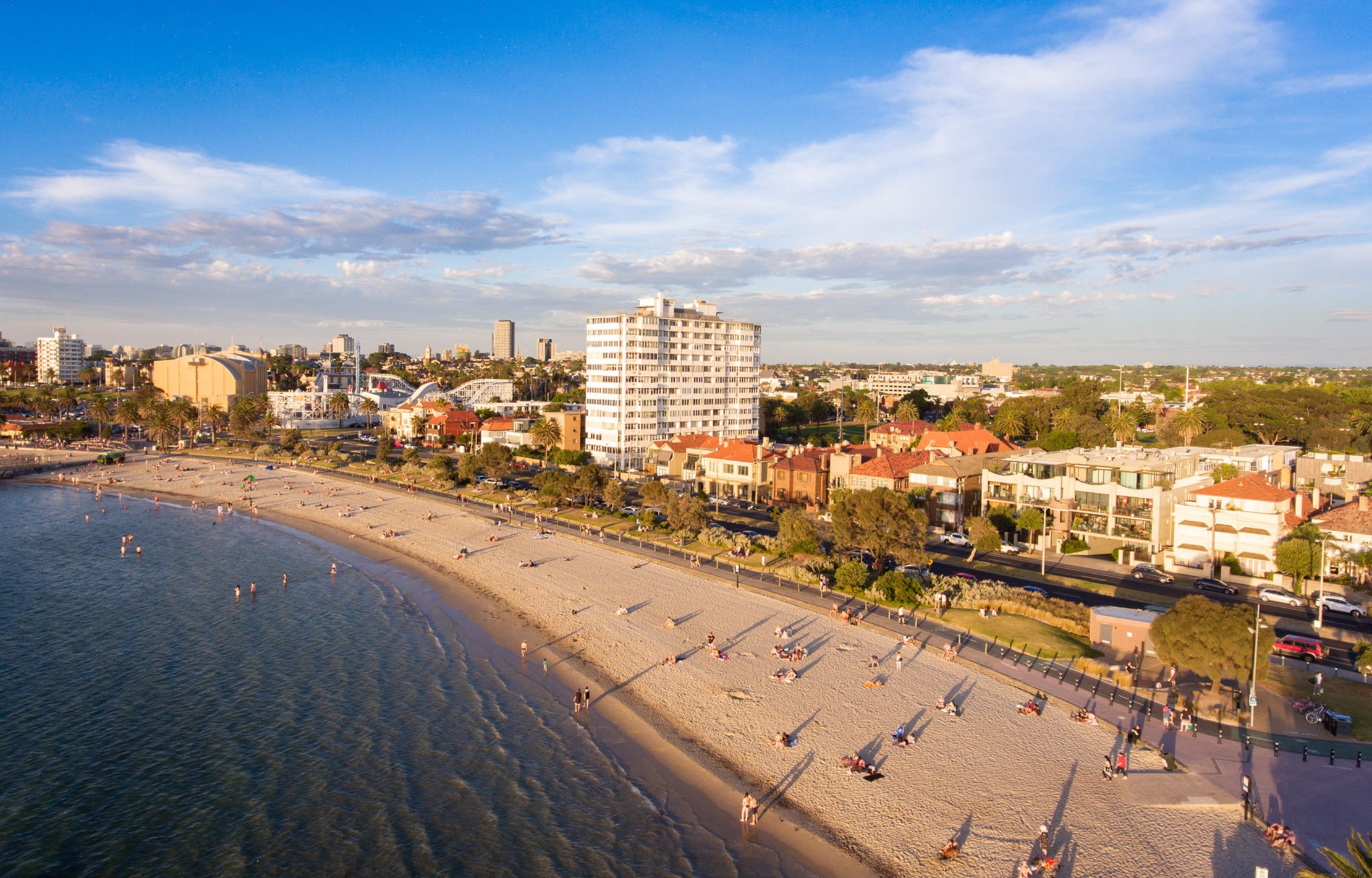 An arial view of the St Kilda foreshore bathed in a golden sunset light.