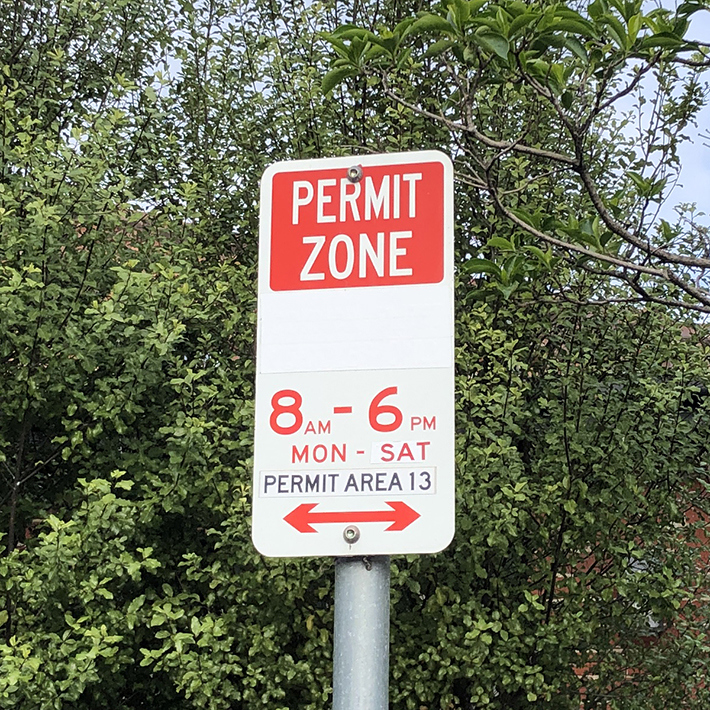 Parking sign for a permit zone from 8 am to 6 pm Monday to Saturday