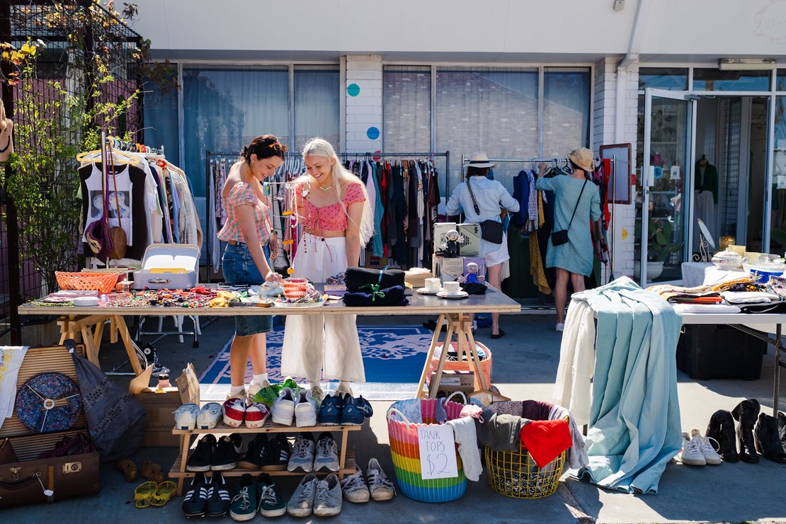 Two young women looking at items at a garage sale