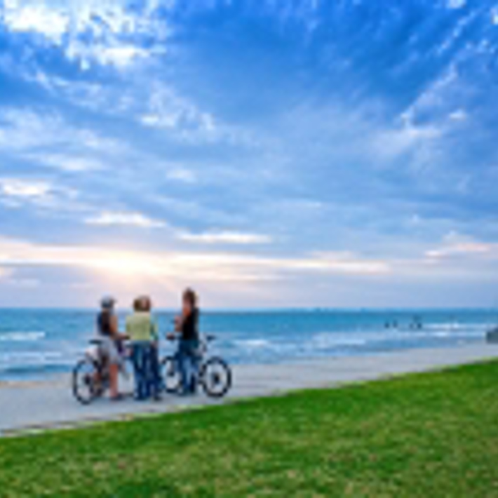 Cyclists on foreshore trail stopped in Elwood looking out to the Bay