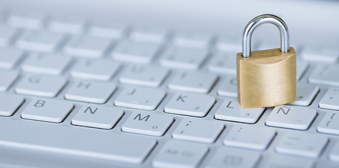 A small, locked padlock on a white keyboard