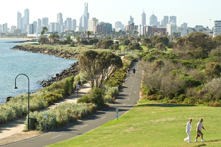 Looking across the bay towards the city skyline from the grassy hill of Point Ormond Reserve