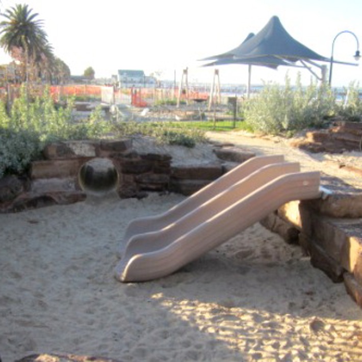 Slides, tunnels and shade sails at Plum Garland playground