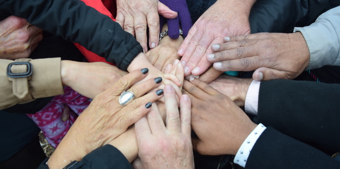 Hands stacked on top of each other 