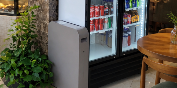 An ELIoT Energy smart battery at work in a hospitality venue, attached to a fridge containing drink cans and bottles. 