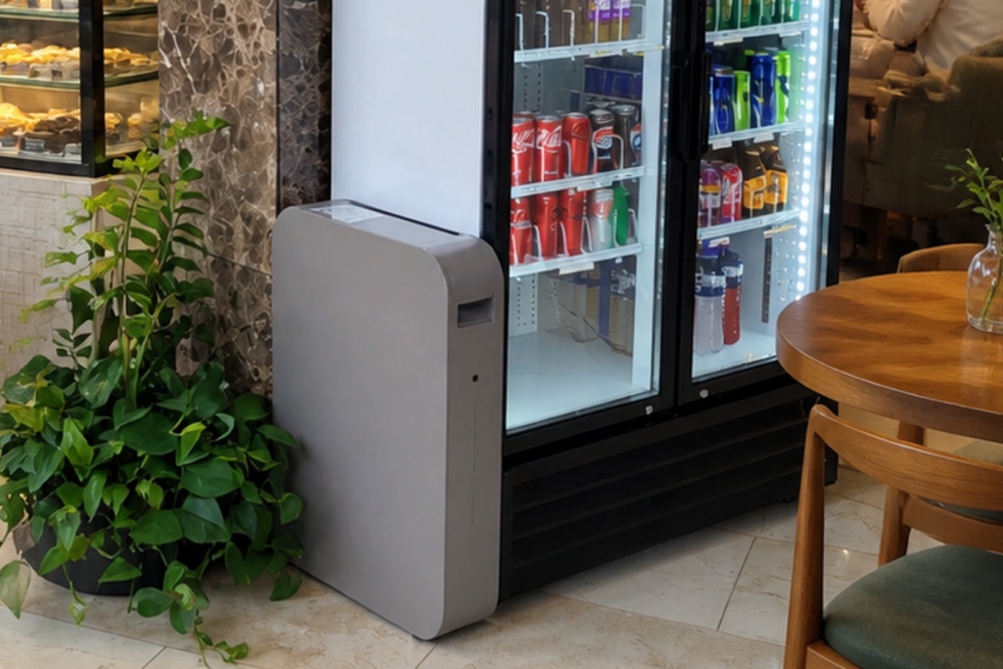 An ELIoT Energy smart battery at work in a hospitality venue, attached to a fridge containing drink cans and bottles.