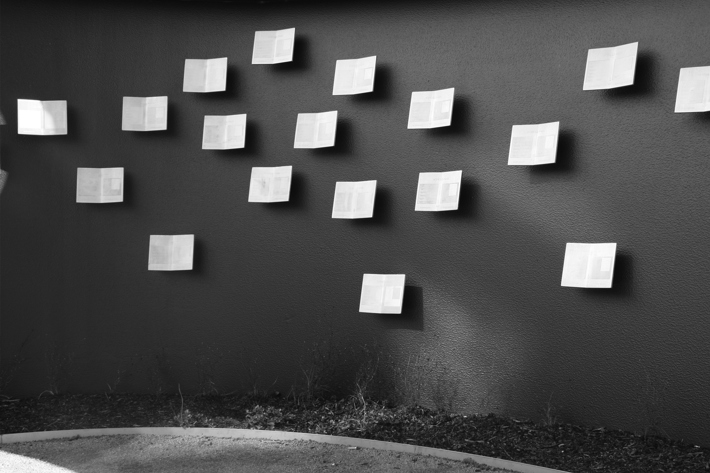 A curved wall with 3 dimensional etched steel replicas of the "schutz-pass'used by Wallenberg to save Jewish citizens during WW2