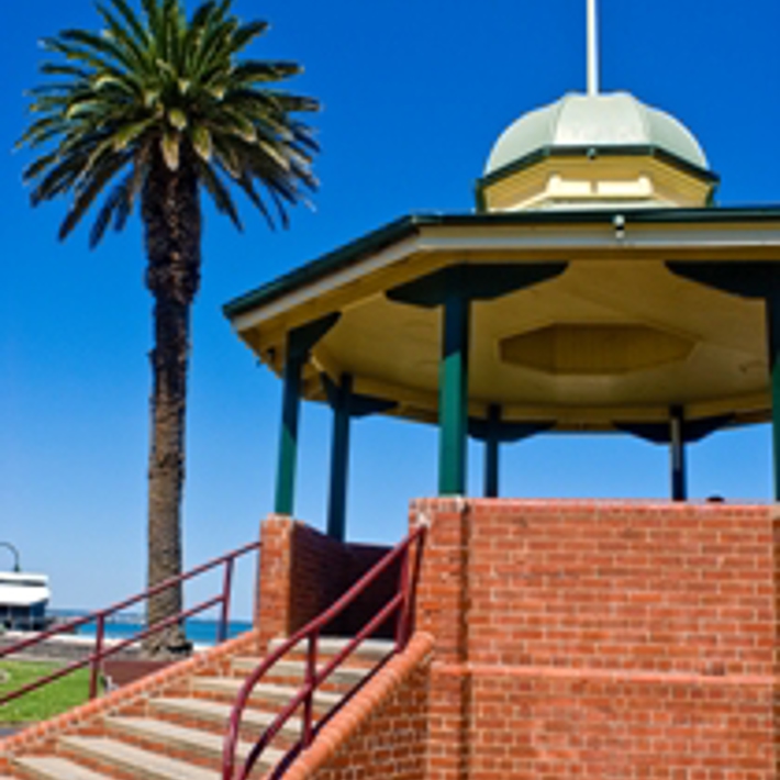 Port Melbourne Bandstand Rotunda with palm tree and Port Melbourne beach in the background
